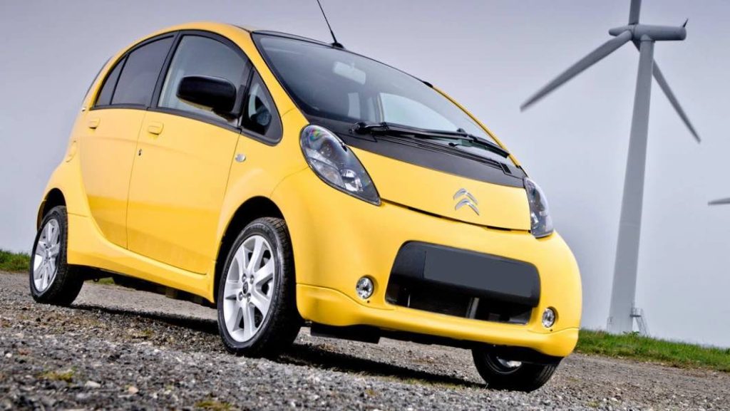 Brukte elbiler: En gul Citroën C Zero foran en vindmølle